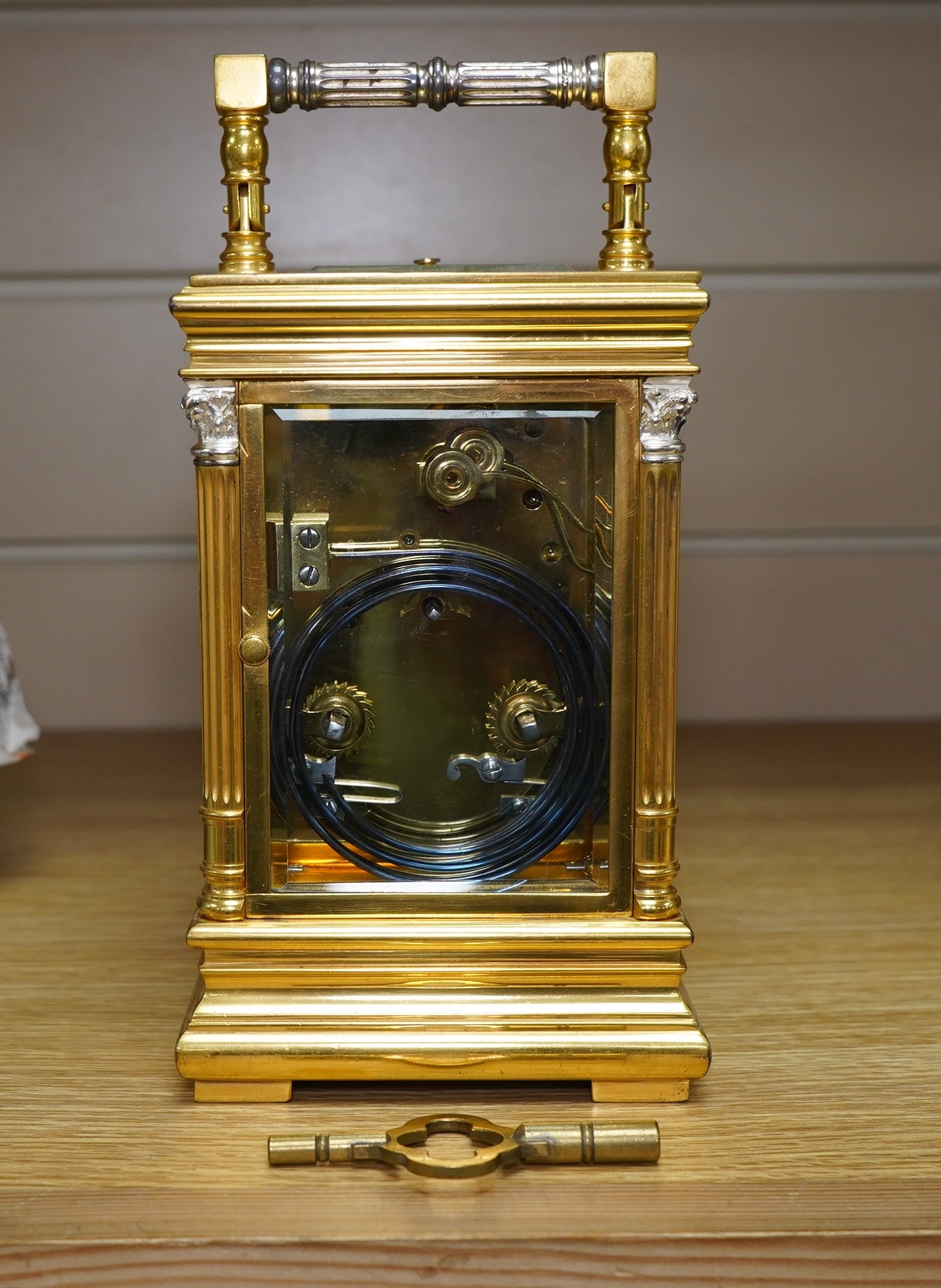 A French silvered and gilt brass hour repeating carriage clock with enamel dial, with key, 20cm high. Condition - good, untested